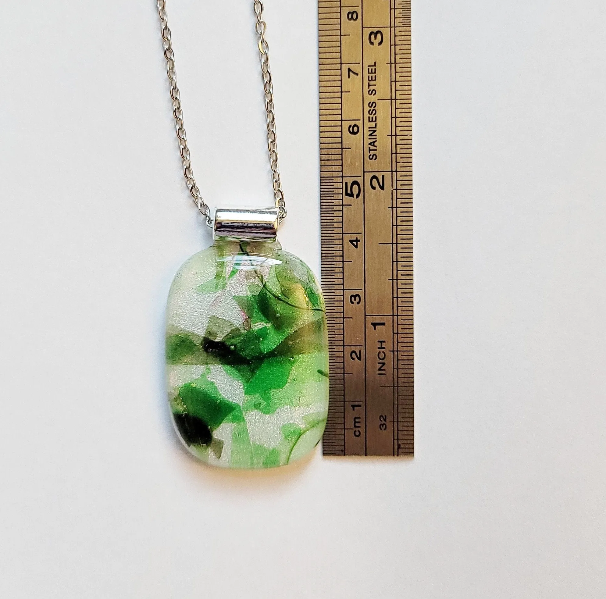 Dichroic green floral on white fused glass statement pendant necklace on 24 inch steel chain. 1.75 x 1 inch pendant