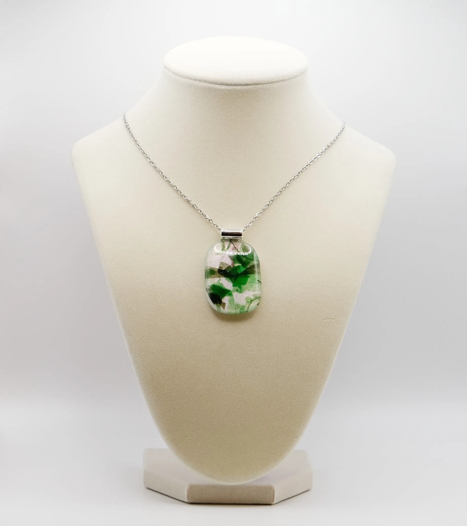 Dichroic green floral on white fused glass statement pendant necklace on 24 inch steel chain. 1.75 x 1 inch pendant